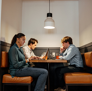 Group of Sandbox team members at table working