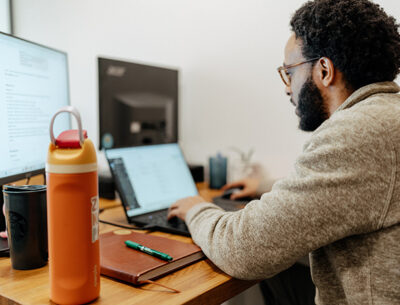 Sandbox team member looking at laptop