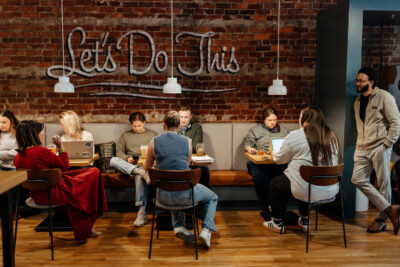 Sandbox team working together at tables during happy hour