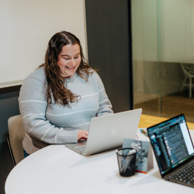 Sandbox team member working at laptop